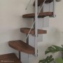 Raumspartreppe Quadro: Dunkle Buche-Walnuss-Stufen, silbernes Metallgeländer. Moderne Mittelholmtreppe für Innenräume.