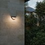 Philips Swyn Solar-Wandleuchte, schwarz, warmweißes Licht an Hauswand.