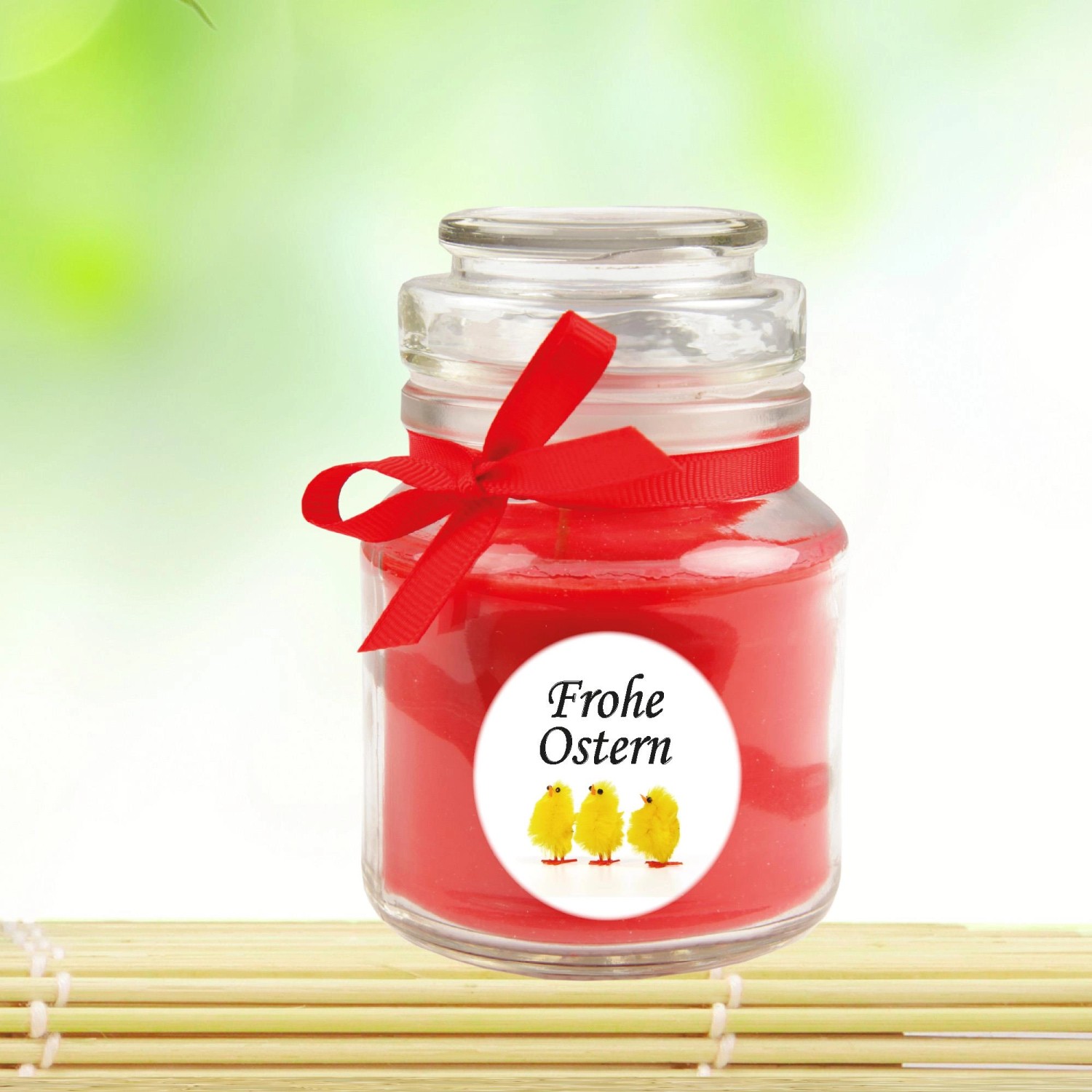Duftkerze "Frohe Ostern" im Glas mit Küken-Motiv und roter Schleife, Ø7cm.