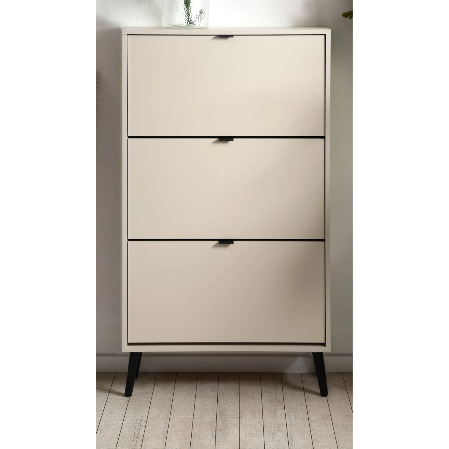 Schuhschrank Aldan in Samt-Optik, beige mit drei Klappen und schwarzen Füßen.
