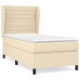 Cremefarbenes Boxspringbett 100x200 cm mit Matratze und Kopfteil aus Stoff.