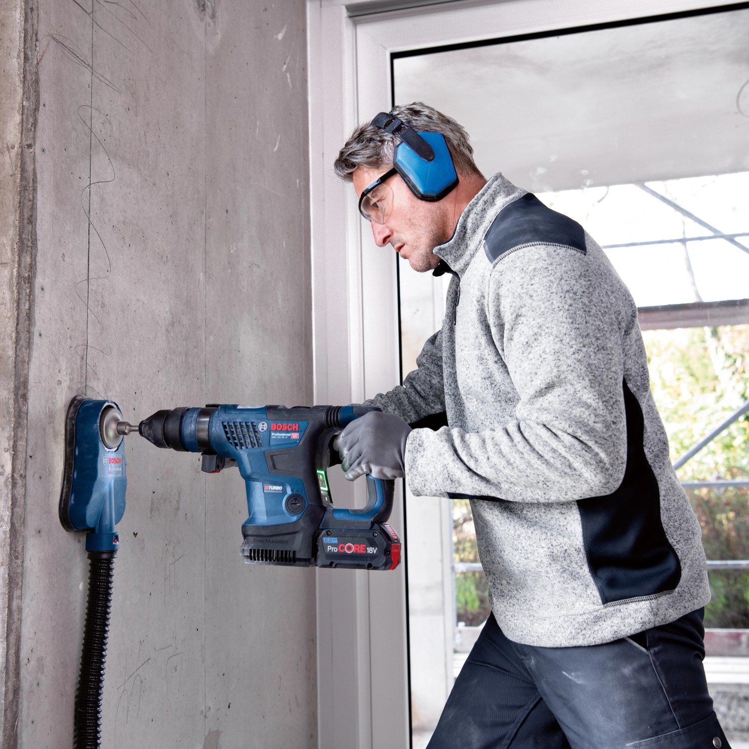 Bosch Professional Akku-Bohrhammer GBH 18V-34 im Einsatz beim Bohren in Betonwand.
