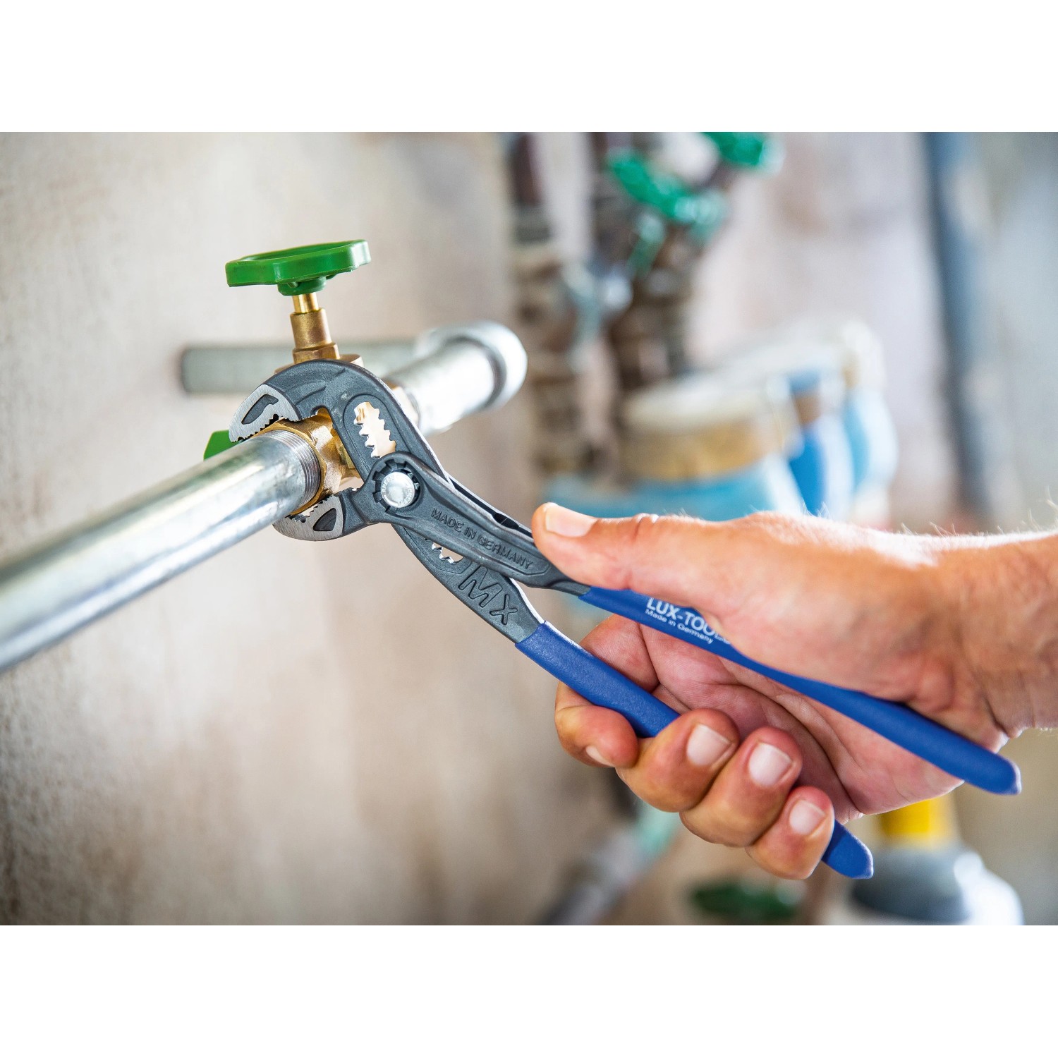 LUX Wasserpumpenzange MX Comfort 300 mm im Einsatz an einem Wasserrohr.