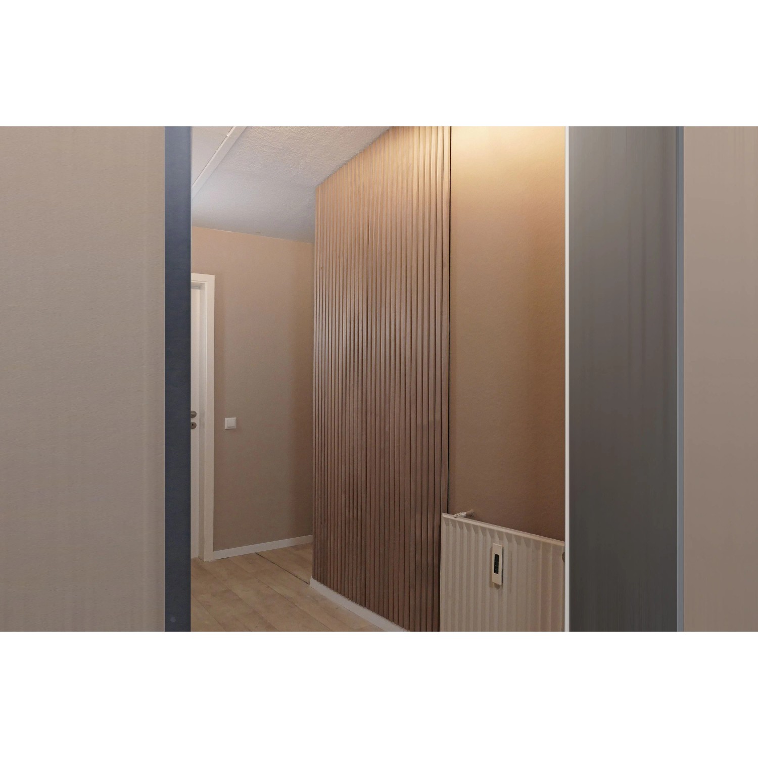 Modernes Flurdesign mit vertikalen Holzlamellen an der Wand und Heizkörper. Perfekt für Soudal Fix All High Tack Kraftkleber.