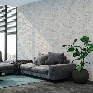 Wohnraum mit grauer Livingwalls Tapete in Beton-Optik, moderner Stil.