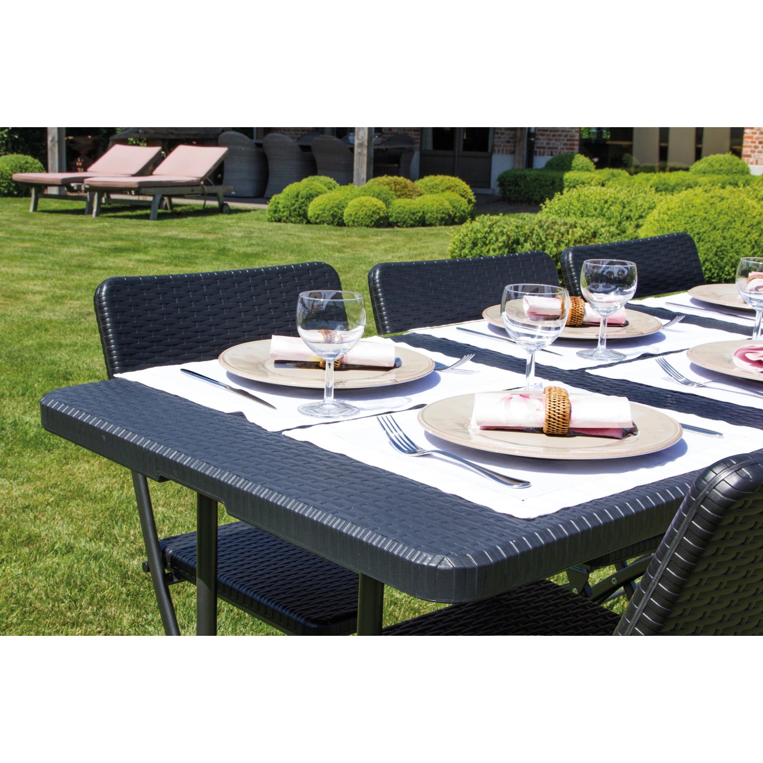 Schwarzer, rechteckiger Perel Klapptisch (75x180 cm) für den Garten, gedeckt mit Geschirr.