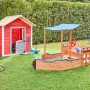 Home Deluxe Sandkasten Matschekiste in Schiffsform mit Sonnendach im Garten.