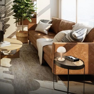 Brilo Tischleuchte Wanda in Coffee-Warmgrey auf Beistelltisch neben braunem Sofa.