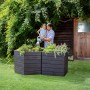 Garantia Hochbeet Ergo Vario 3 Wood mit Mann und Kind beim Gießen im Garten.