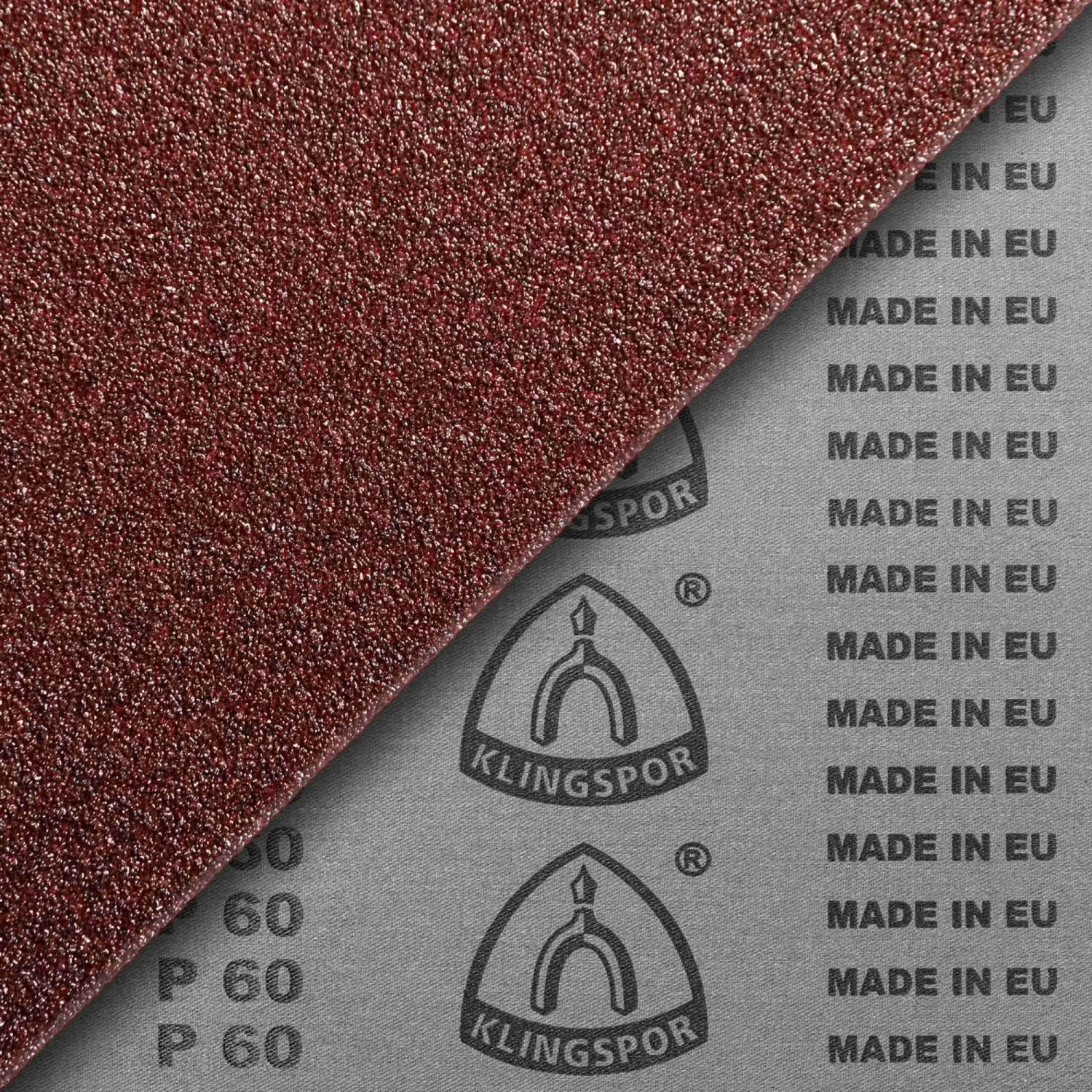 Rotbraunes Klingspor Schleifband Korund Korn 60 auf grauem Gewebe mit Logo und "MADE IN EU" Aufdruck. Zubehör für Bandschleifer.