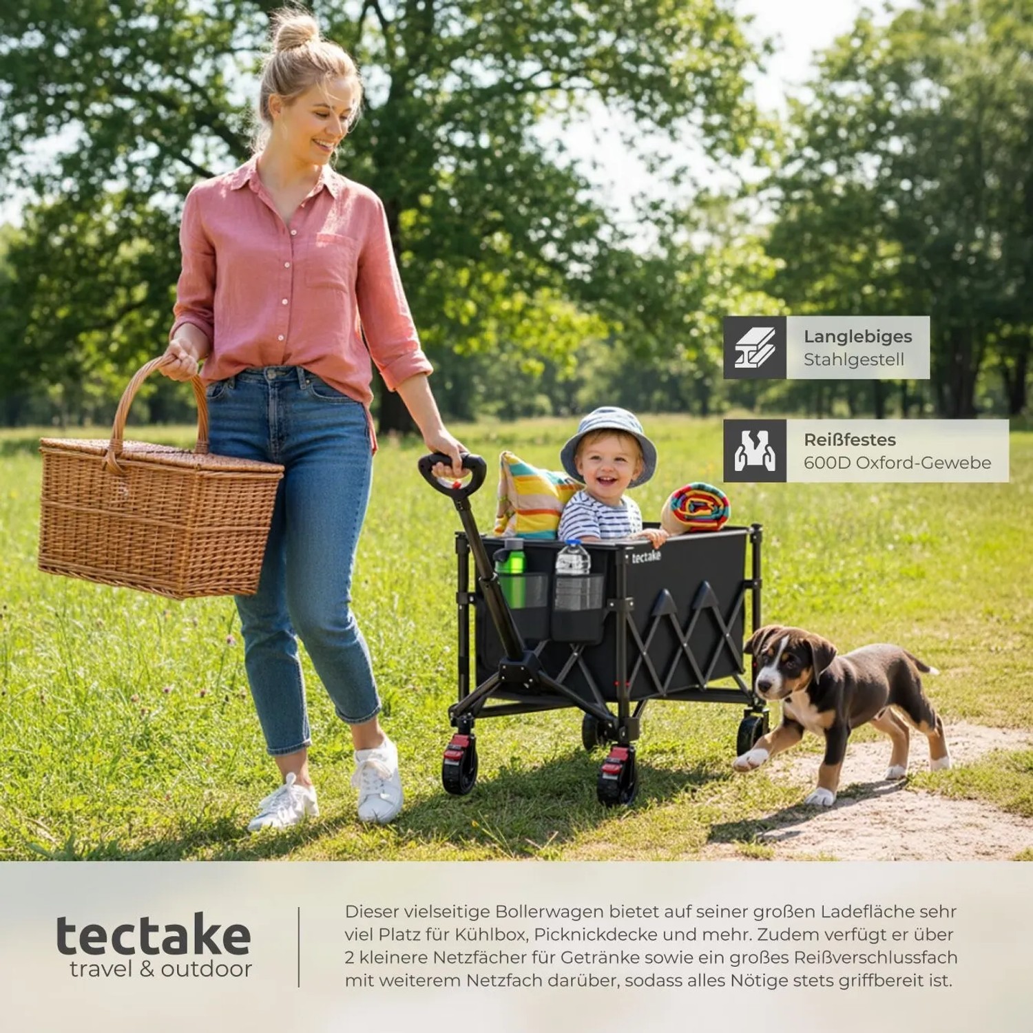 Faltbarer, schwarzer Tectake Bollerwagen mit Kind, Hund und Picknick-Korb im Grünen.
