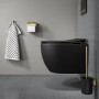 Tiger Tune WC-Bürste mit Halter, Messing gebürstet/Schwarz, an Wand montiert.