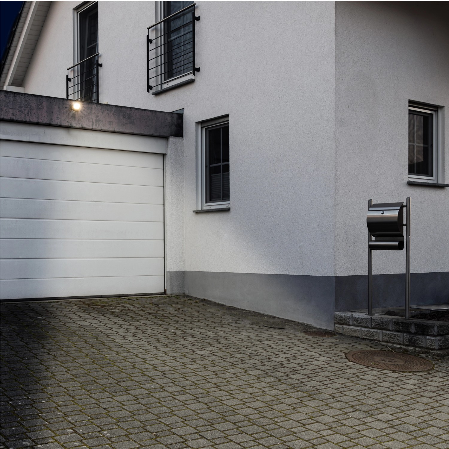 Schwarzer LED's light Wandstrahler (20W) an Hauswand über Garage montiert.