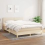Cremefarbenes Boxspringbett 140x190 cm mit Matratze und Kopfteil aus Stoff.
