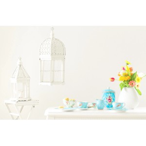 Dekorative Szene mit Alpina Farbrezepte Wolkenreise Wandfarbe, Teegeschirr und Blumen.