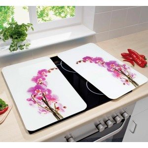 Wenko Herdabdeckplatten-Set mit Orchideenblüten-Motiv auf einem Herd.