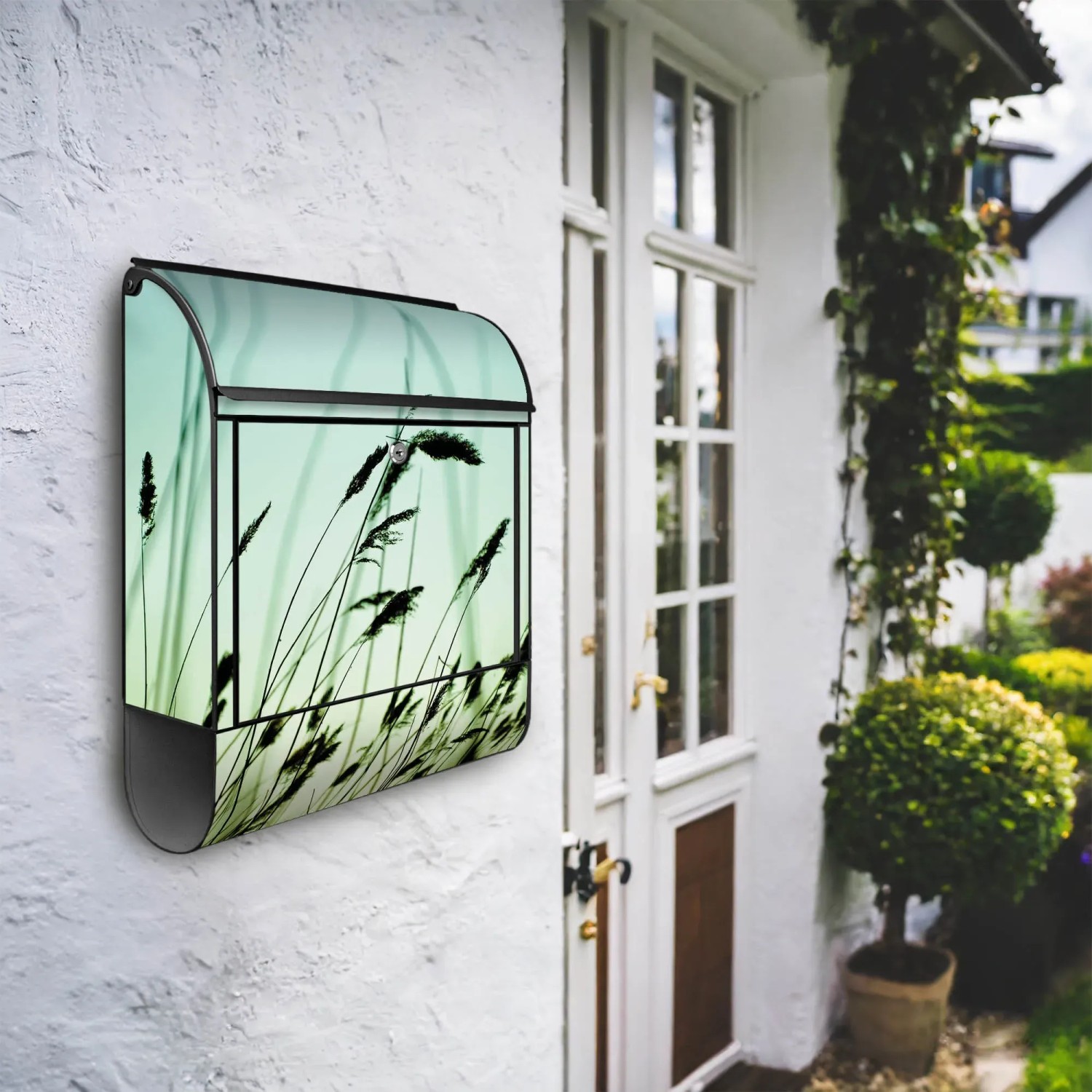 Schwarzer Design Briefkasten mit Gräser Motiv und Zeitungsfach. Wandbriefkasten aus pulverbeschichtetem Stahl.