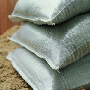 Stapel aus drei gefüllten, hellgrauen Sandsäcken (10er Pack) aus PP-Kunststoff.