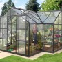 Schwarzes Vitavia Gewächshaus Sirius mit 13 m², ESG-Verglasung und Fundament im Garten.