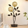 Schwarze Lucande Tischlampe Evory im Florentiner Design mit zwei floralen Lampenschirmen.