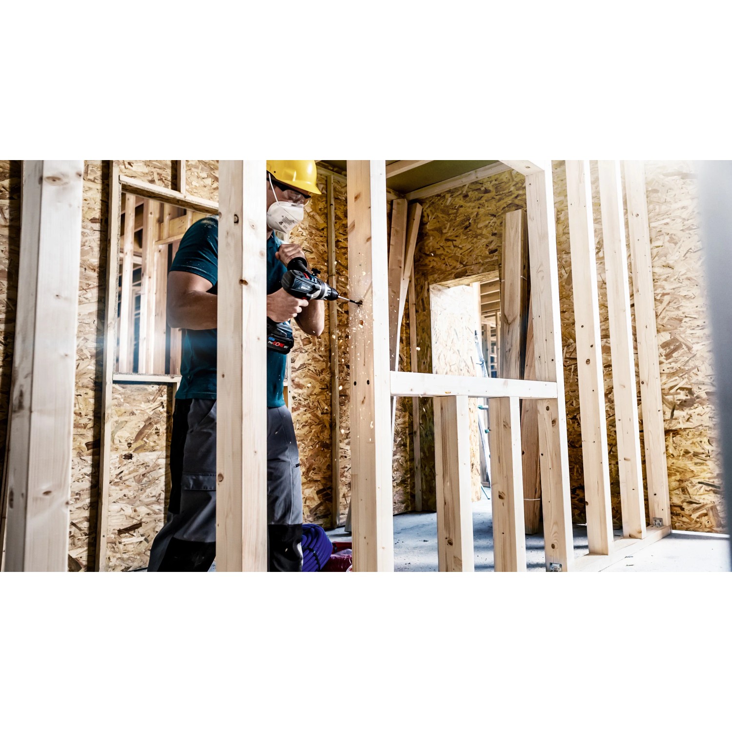 Handwerker bohrt mit Bosch Flachfräsbohrer Expert Self Cut Speed in Holzkonstruktion.