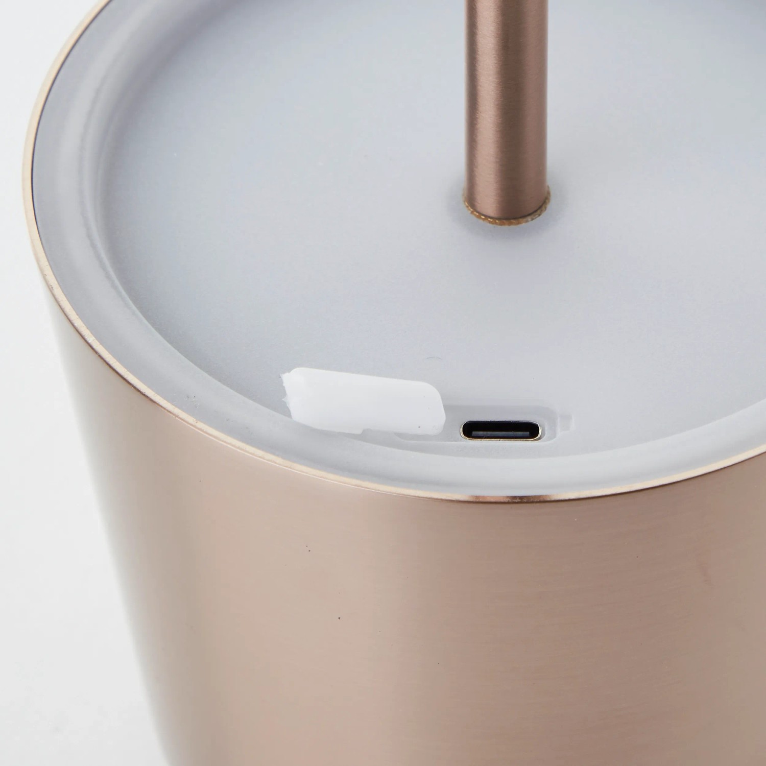 Detailaufnahme der Akku-Tischleuchte Xaana in hellem Kupfer mit USB-Anschluss.