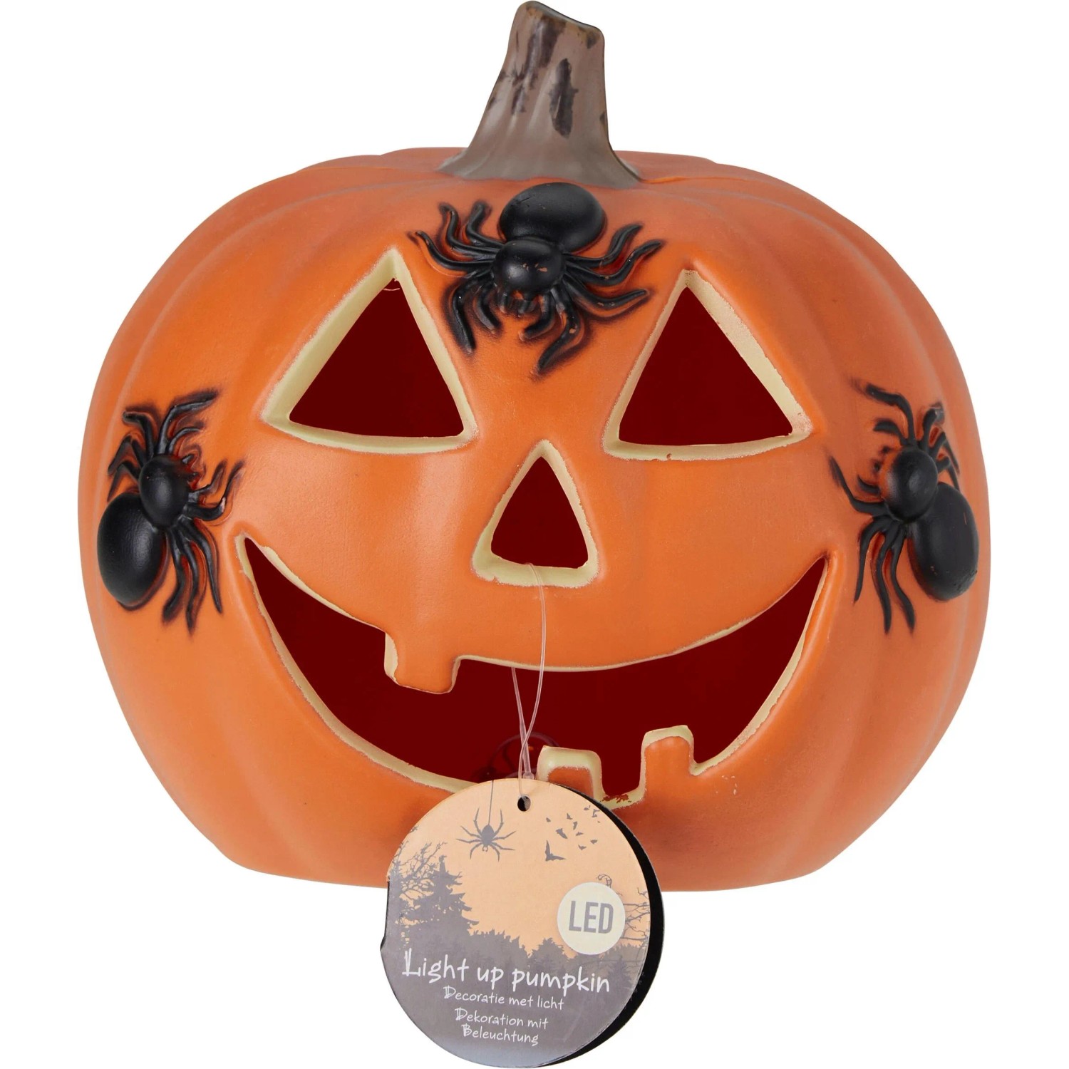 Oranger Halloween-Kürbis mit leuchtendem Gesicht und drei schwarzen Spinnen. Dekorative Figur mit Licht.