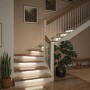 Paulmann MaxLED Stair LED-Streifen-Erweiterung beleuchtet eine moderne Holztreppe stilvoll. Warmweißes Licht unter den Stufen.