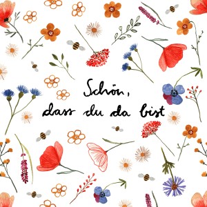Bunte Papierservietten mit Blumenmuster und dem Spruch 'Schön, dass du da bist'.