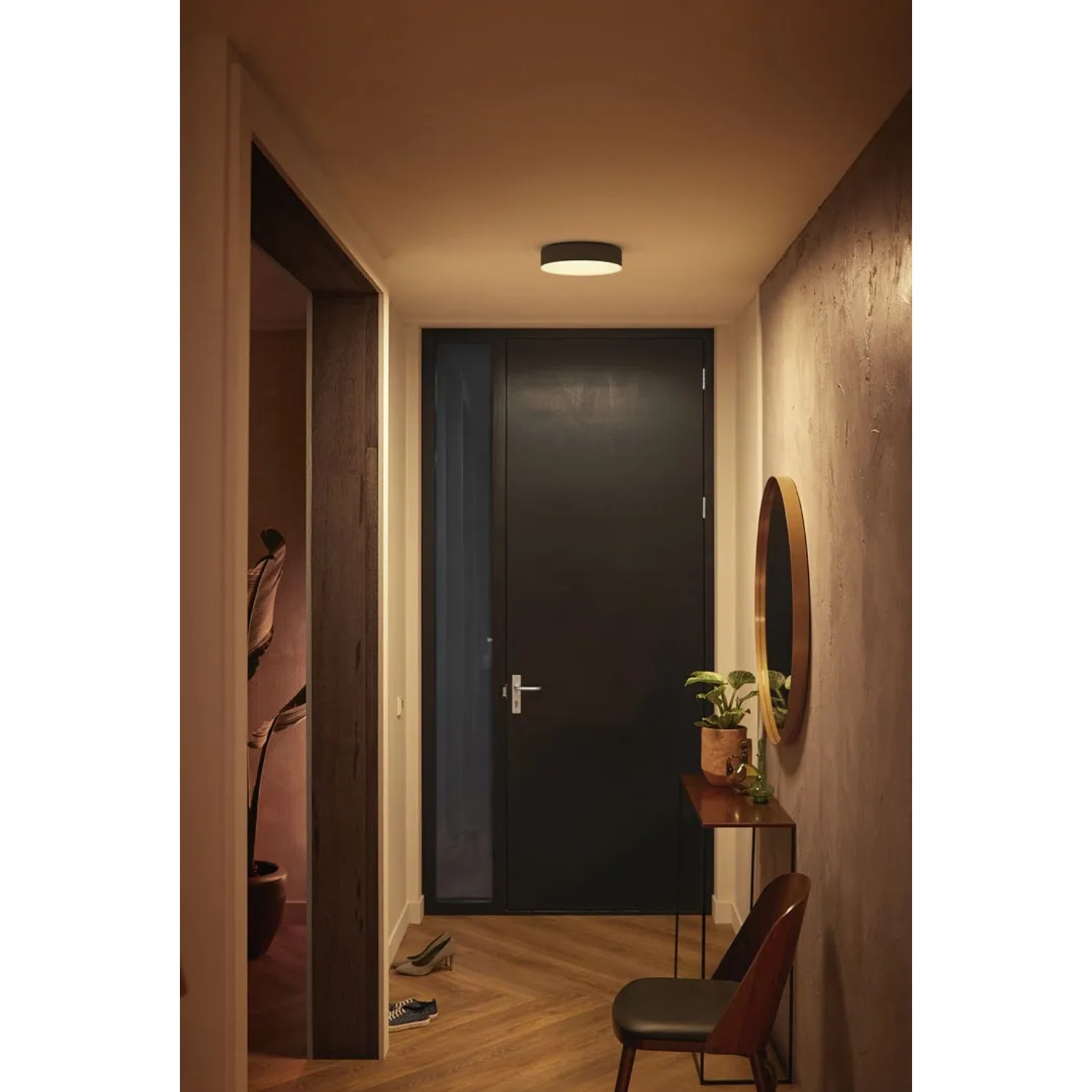 Schwarze Philips Hue Enrave S Deckenleuchte White Ambiance im Flur mit Dimmer.