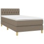 Taupes Boxspringbett 90x190 cm mit Matratze und weißem Topper.