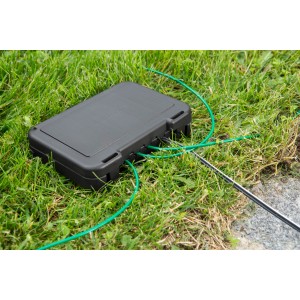 Gardena Kabelverbinder-Schutz für Mähroboter auf Rasen mit Kabeln.