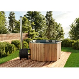 Finntherm Badefass Kopenhagen aus Thermoholz mit Außenofen auf Holzterrasse im Garten.