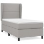 Helles Boxspringbett 90x190 cm mit Matratze und Kopfteil, Stoff hellgrau.