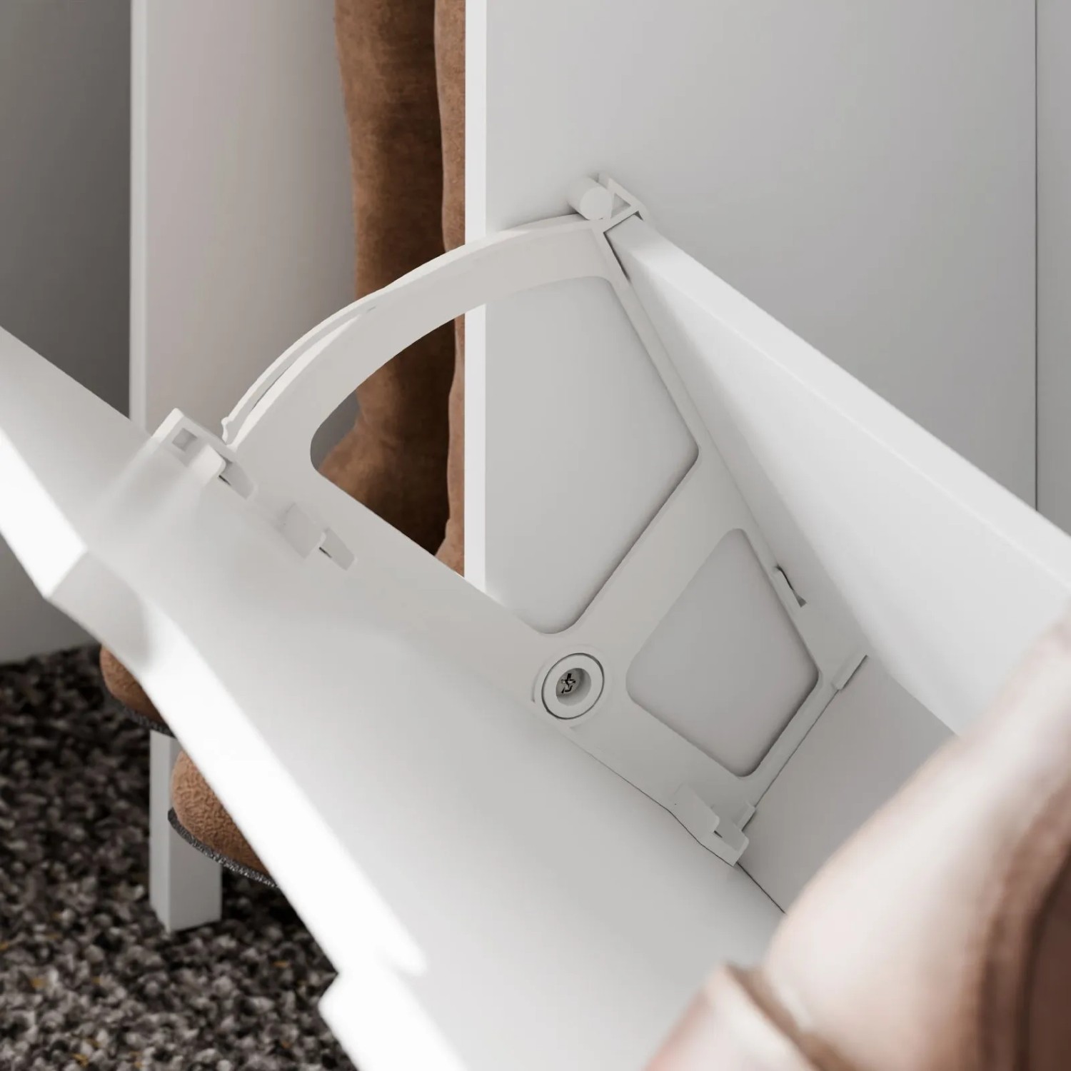 Weißer schmaler Schuhschrank mit geöffneter Klappe, die ein Schuhfach und einen braunen Stiefel zeigt. Schuhkommode.