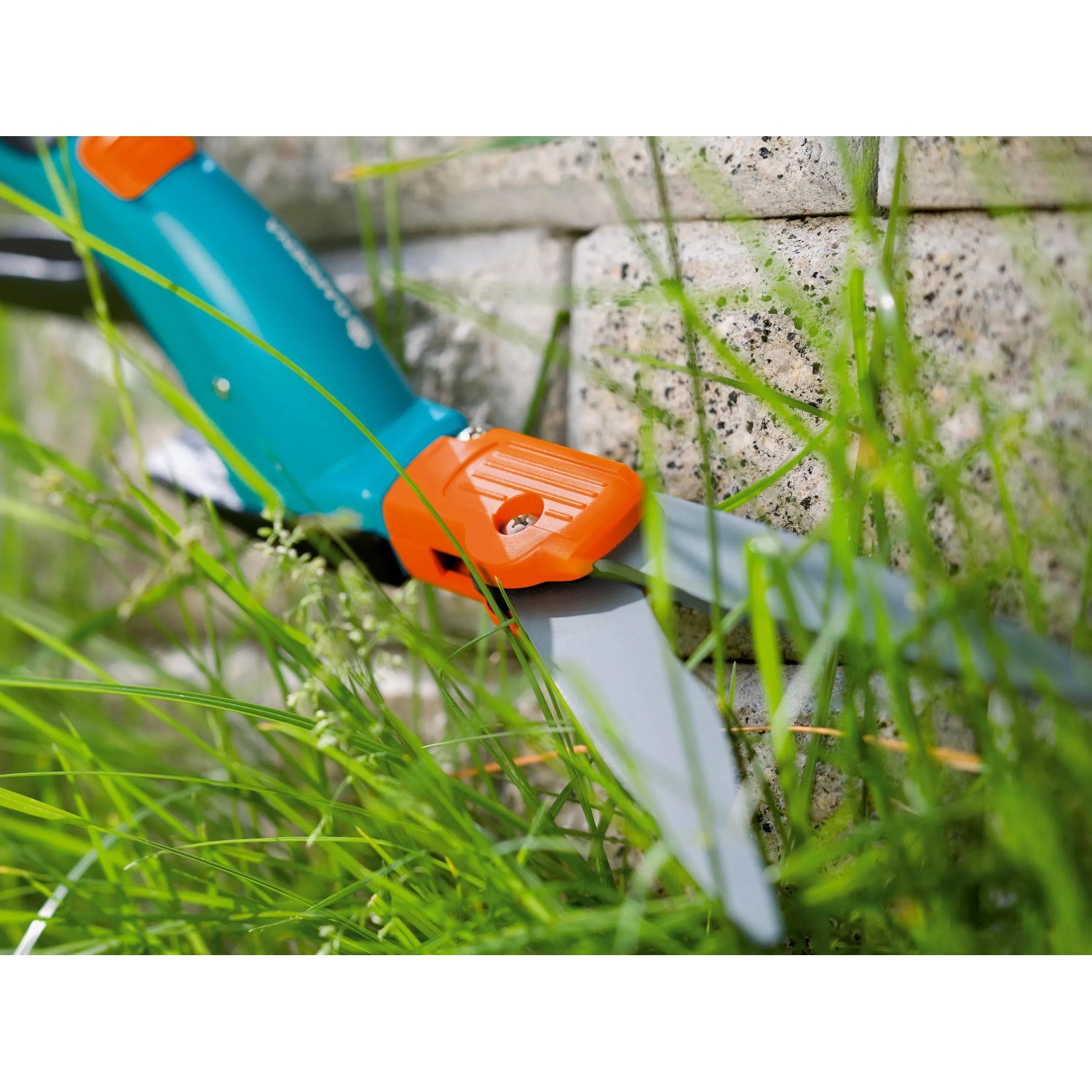 Gardena Comfort Grasschere mit drehbarem Kopf beim Rasenkantenschnitt.