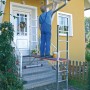 Krause Corda Leiter-Gerüst mit Person beim Anstreichen einer Hauswand auf einer Arbeitsbühne.