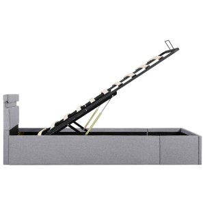 Hellgraues Stoffbett 90x200 mit Bettkasten und LED, hydraulisch geöffnet.