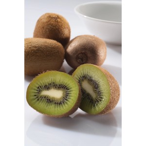 Frische Kiwis, ganze und halbiert, vor einer weißen Schale. GROW by OBI Kiwi.