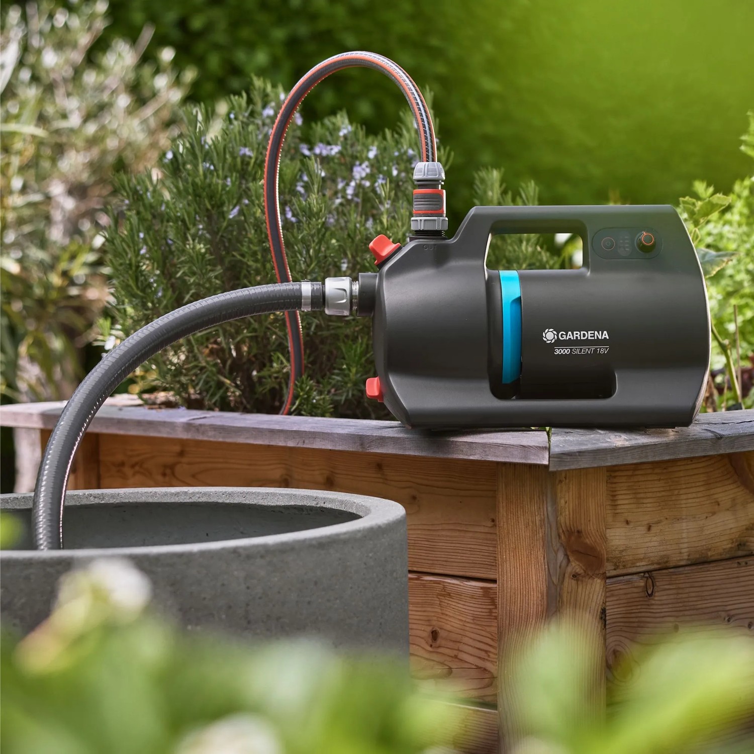 Gardena Akku-Gartenpumpe 3000 Silent 18 V P4A Solo im Einsatz mit Schläuchen an Zisterne.