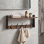 Dunkelbraunes Schlüsselbrett aus MDF mit 5 schwarzen Eisenhaken und Ablage im Industrial Design, an grauer Wand montiert.