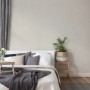 Schlafzimmer mit grauer, strukturierter Vliestapete Uni Matt FSC® an der Wand.