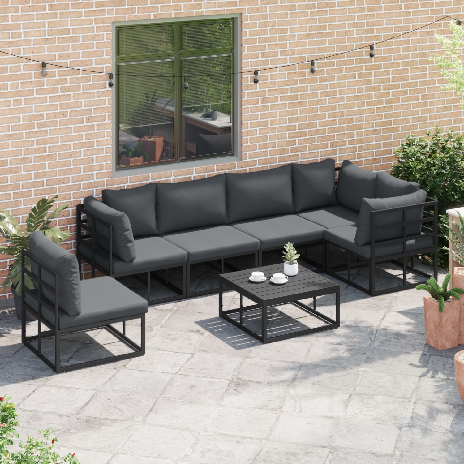 Schwarzes 6-teiliges vidaXL Garten-Sofa-Set mit Tisch und grauen Kissen auf einer Terrasse.