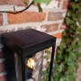 Schwarze, eckige Lutec Solar-Außenwandleuchte Flair mit Bewegungsmelder an Backsteinwand.