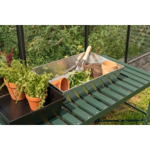 Pergart Pflanzwanne aus galvanisiertem Aluminium mit Erde und Pflanzenzubehör auf einem Gartentisch.