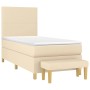 Cremefarbenes Boxspringbett 90x190 cm mit Matratze und Bank, Stoffbezug.