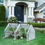 Weißes WOLTU Foliengewächshaus mit Metallrahmen und Pflanzen im Garten.