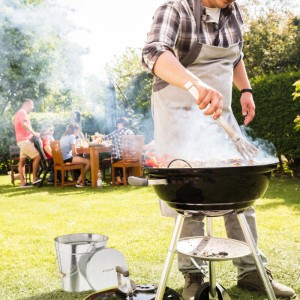 Silberner Relaxdays Ascheeimer aus Stahl mit Deckel neben Grill.