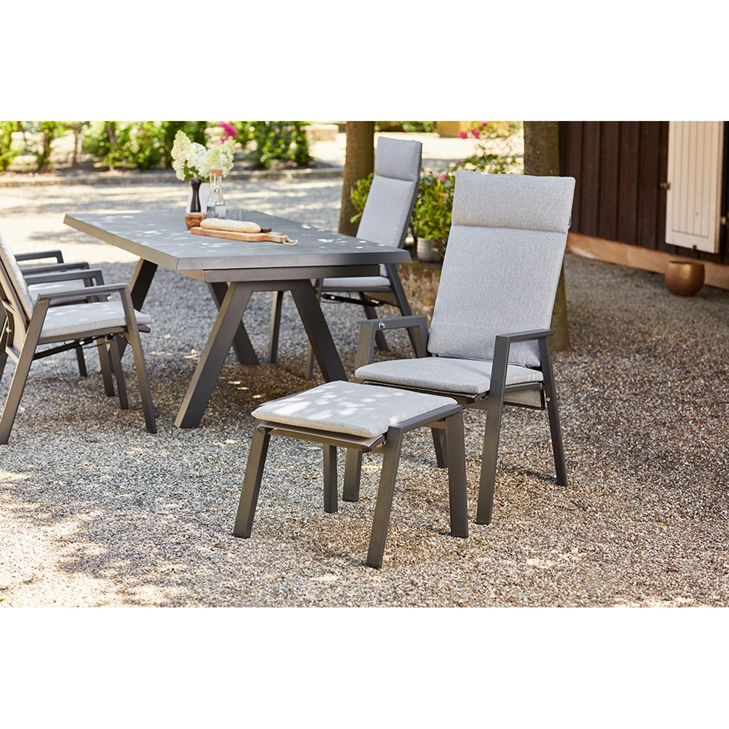 Siena Garden Valencia Dining Move Sessel in Anthrazit-Salt & Pepper mit Gartentisch und Stühlen.