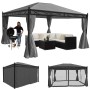 Graue MCW Pergola Calpe 4x3m mit Dach, Seitenwand, Moskitonetz, Grill und Sitzgruppe.